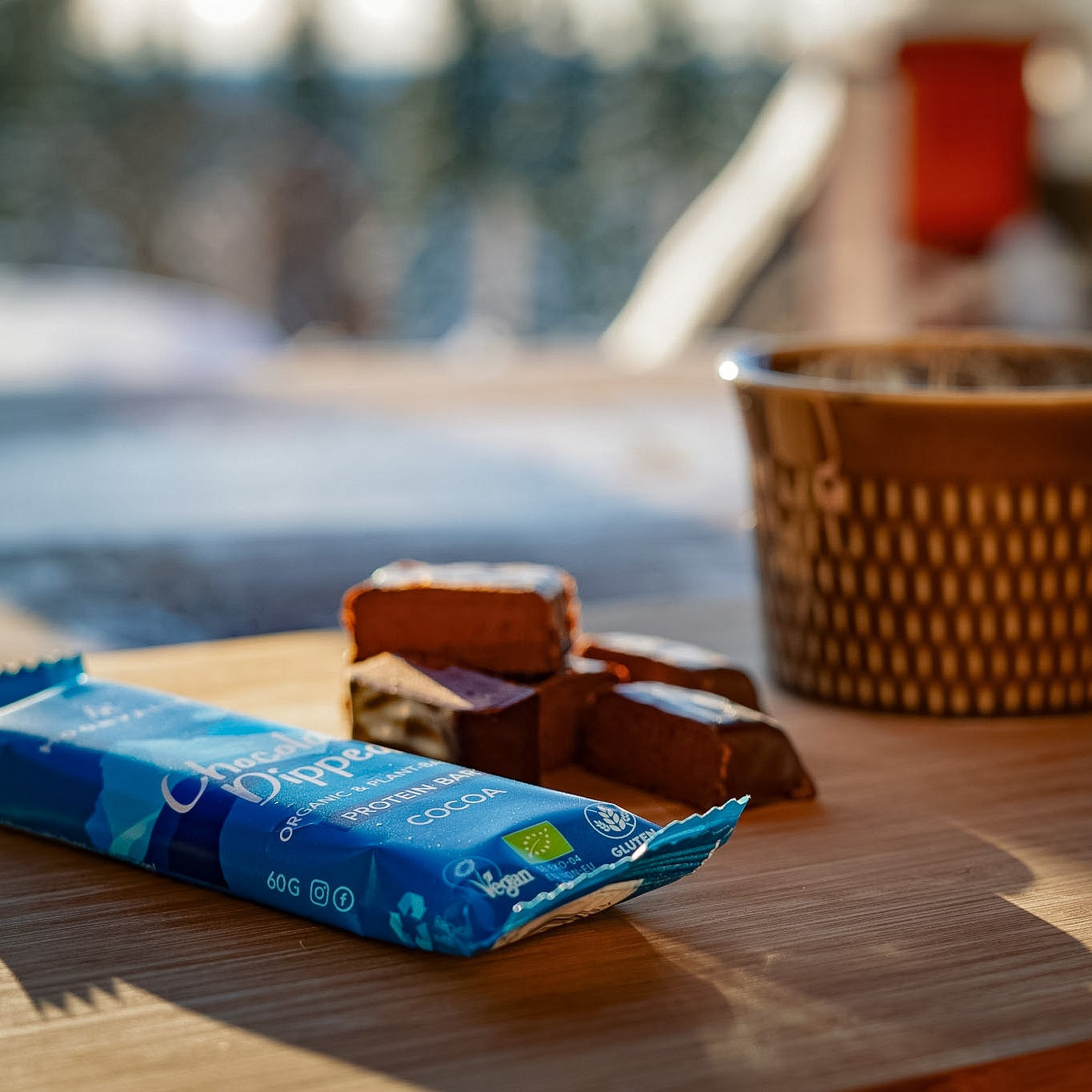 Moonvalley Organic Protein Bar Chocolate-Dipped Cocoa served with sliced protein bar and coffee